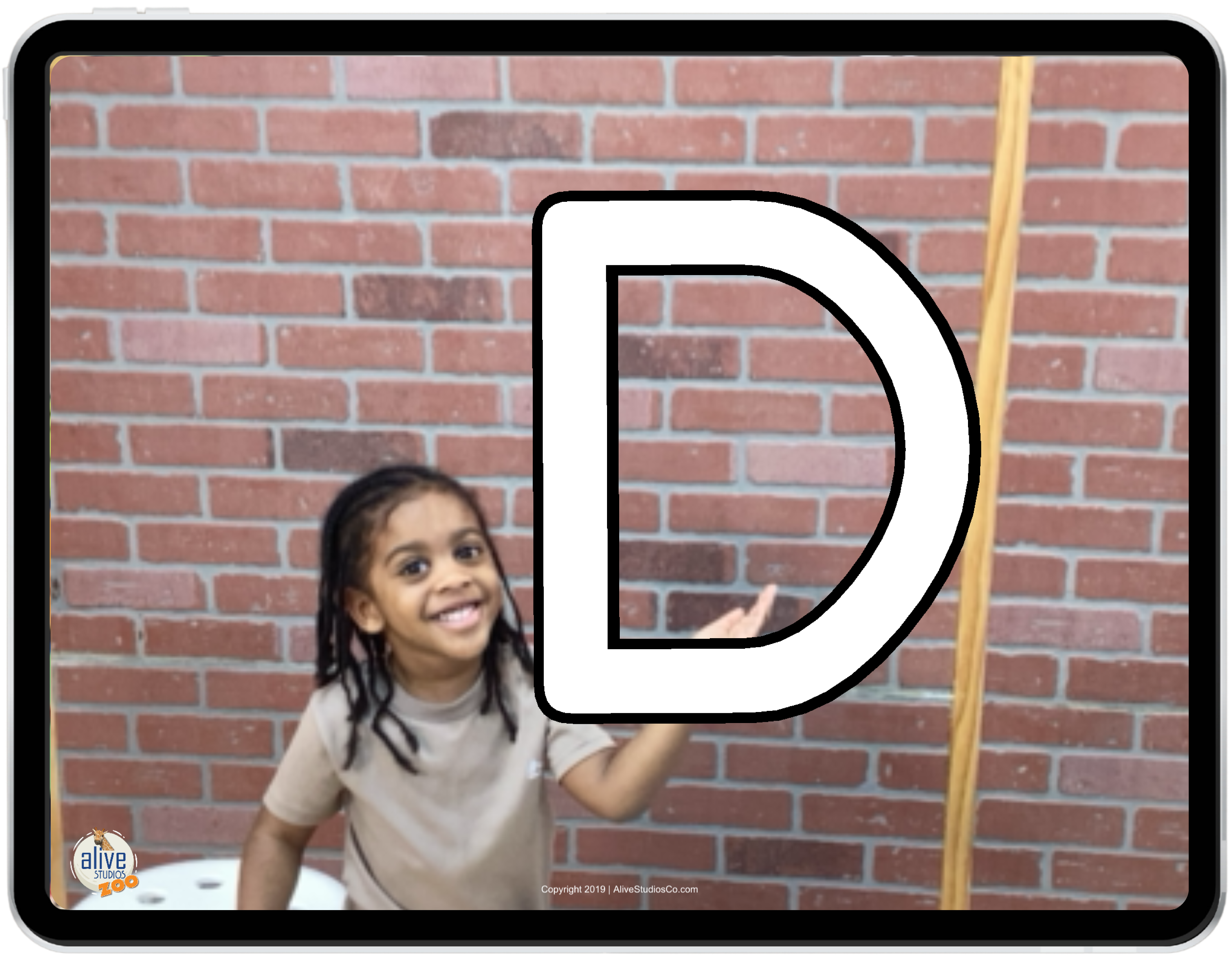Girl showing letter D in iPad